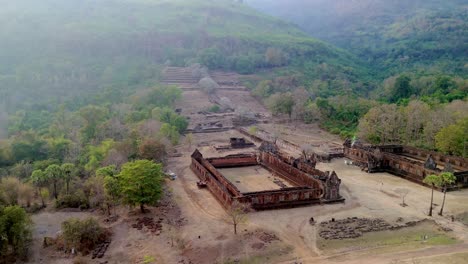 Vat-Phou,-Khmer-temple-in-mystic-hillside-location,-drone-orbit-rotate