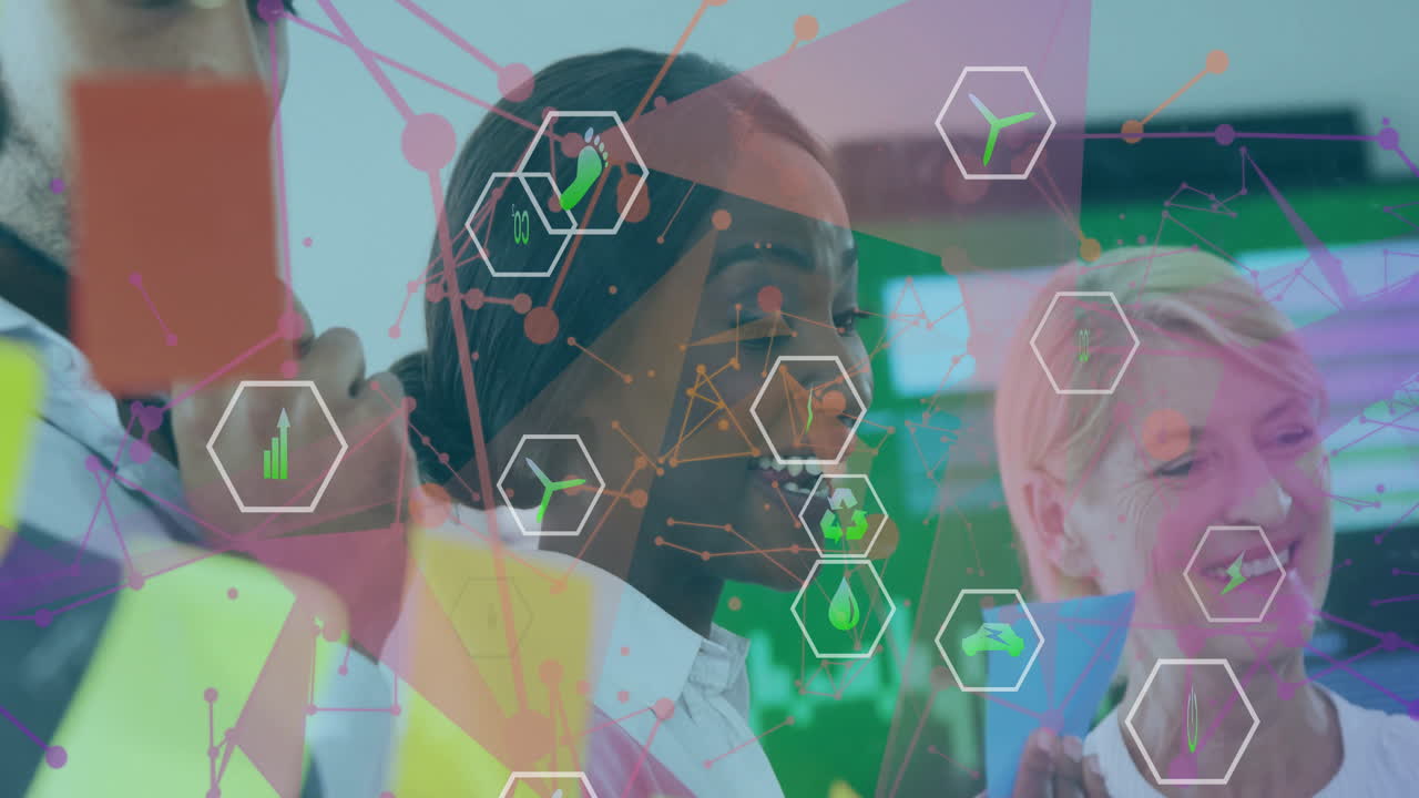 Collaborating on animation, diverse business team with environmental icons overlay