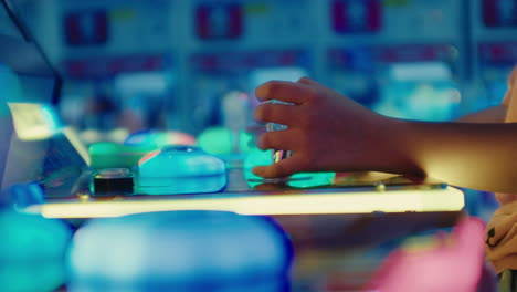 game room area a young kid sitting playing video games arcade alone, close up of teenager hands play controllers