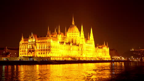 hungarian parlament in budapest during the night from the river dunabe