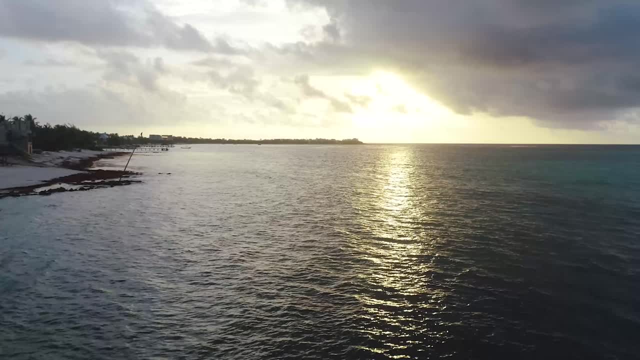 Dock and Boat on Shoreline of the Caribbean Sea in Tulum, Mexico During Sunrise