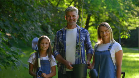 happy family planting a tree