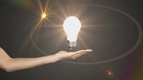 hand holding glowing light bulb, animation of idea and innovation concept