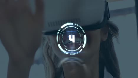 animation of countdown over smiling caucasian businesswoman using virtual reality headset at office