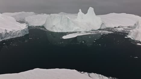 drone over sea and ice of ilulissat icefjord