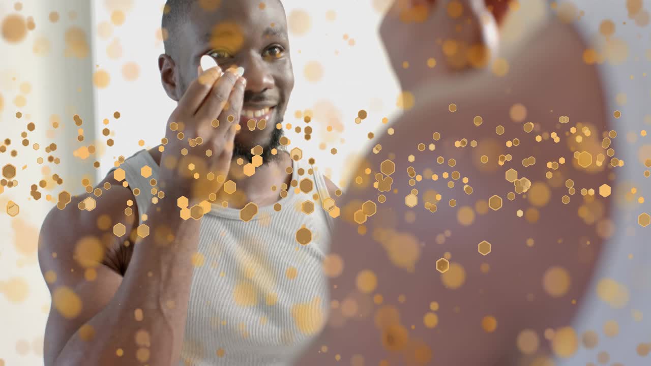 Man lifting hand, applying eye patches at mirror for skincare, adjusting with golden bokeh overlay