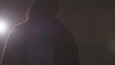 backlit studio shot of young woman dancer dancing in front of spotlight 2