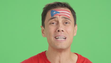 very nervous man supporting puerto rican team during a difficult match