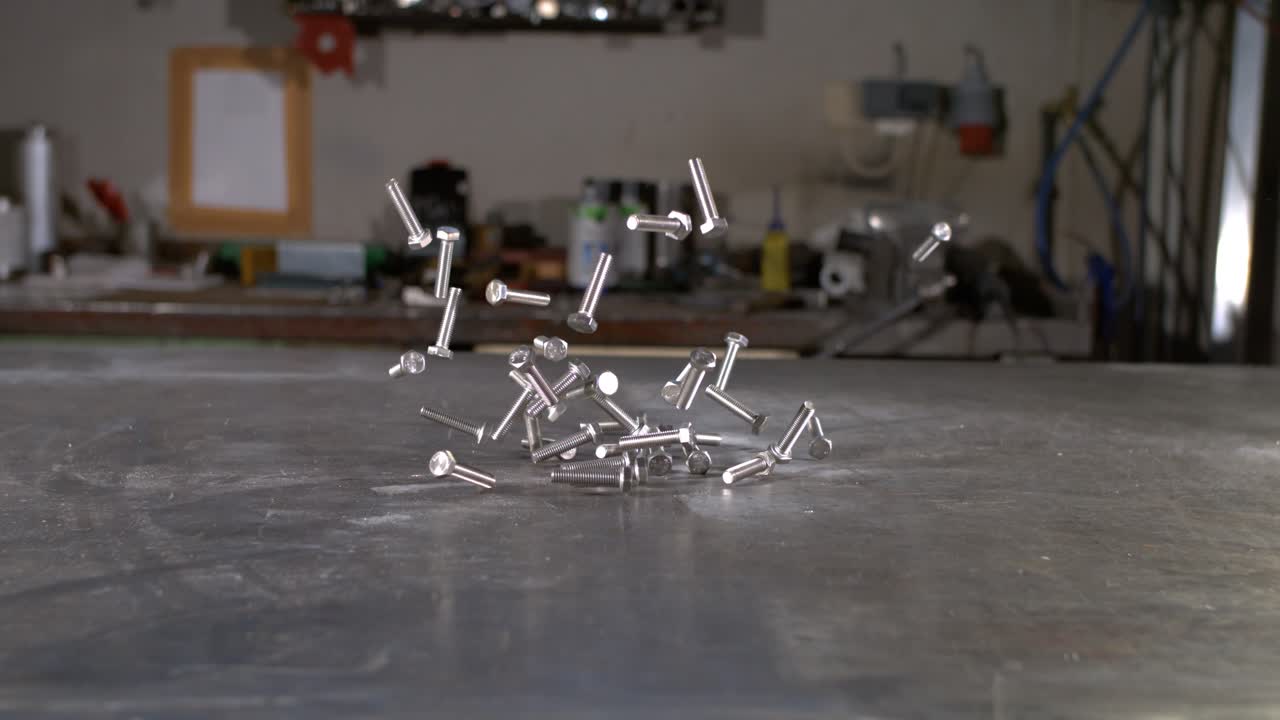 Screws hitting a metal surface in super slow motion