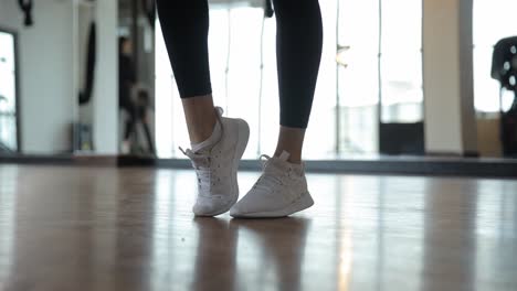 closeup view of energetic footwork displayed in trendy white sneakers highlighting both fitness and closeup view of energetic footwork displayed in trendy white sneakers highlighting both fitness and style