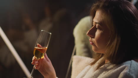 sad lady drinks alcohol to muffle moral pain sitting near window with reflection. female dealing with mental problem that makes feel depressive and alone slow motion