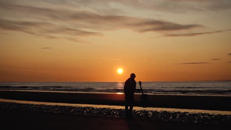 man running with guitar in back sand beach at sunset-11