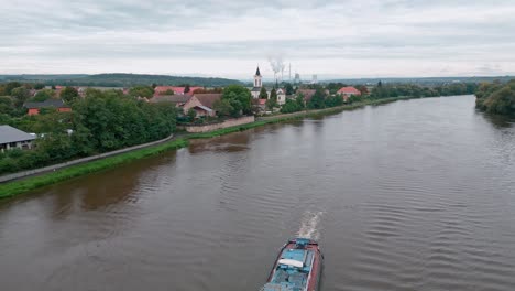 aerial view of the landscape around the elbe river with a tugboat pushing a load of sand down the river