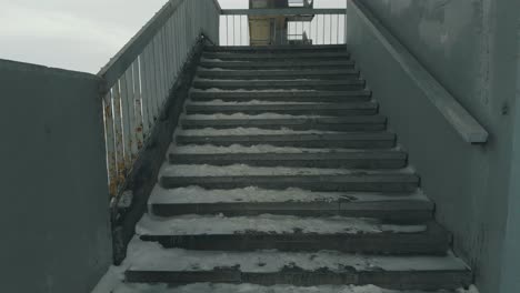 old-grey-stairs-against-frozen-river-covered-with-white-snow