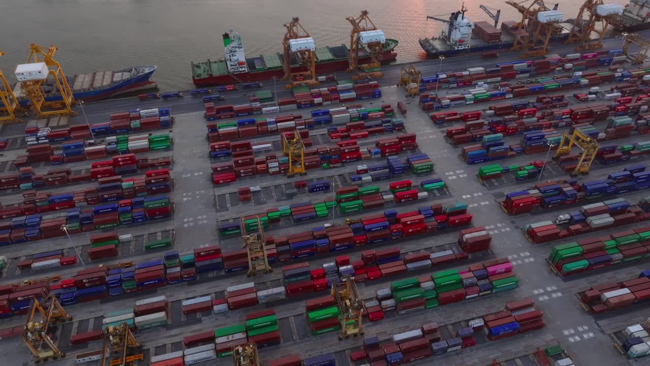 Aerial view of a bustling container port with active cargo operations