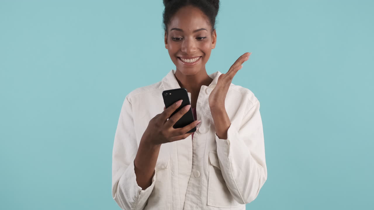 Cheerful woman watching smartphone