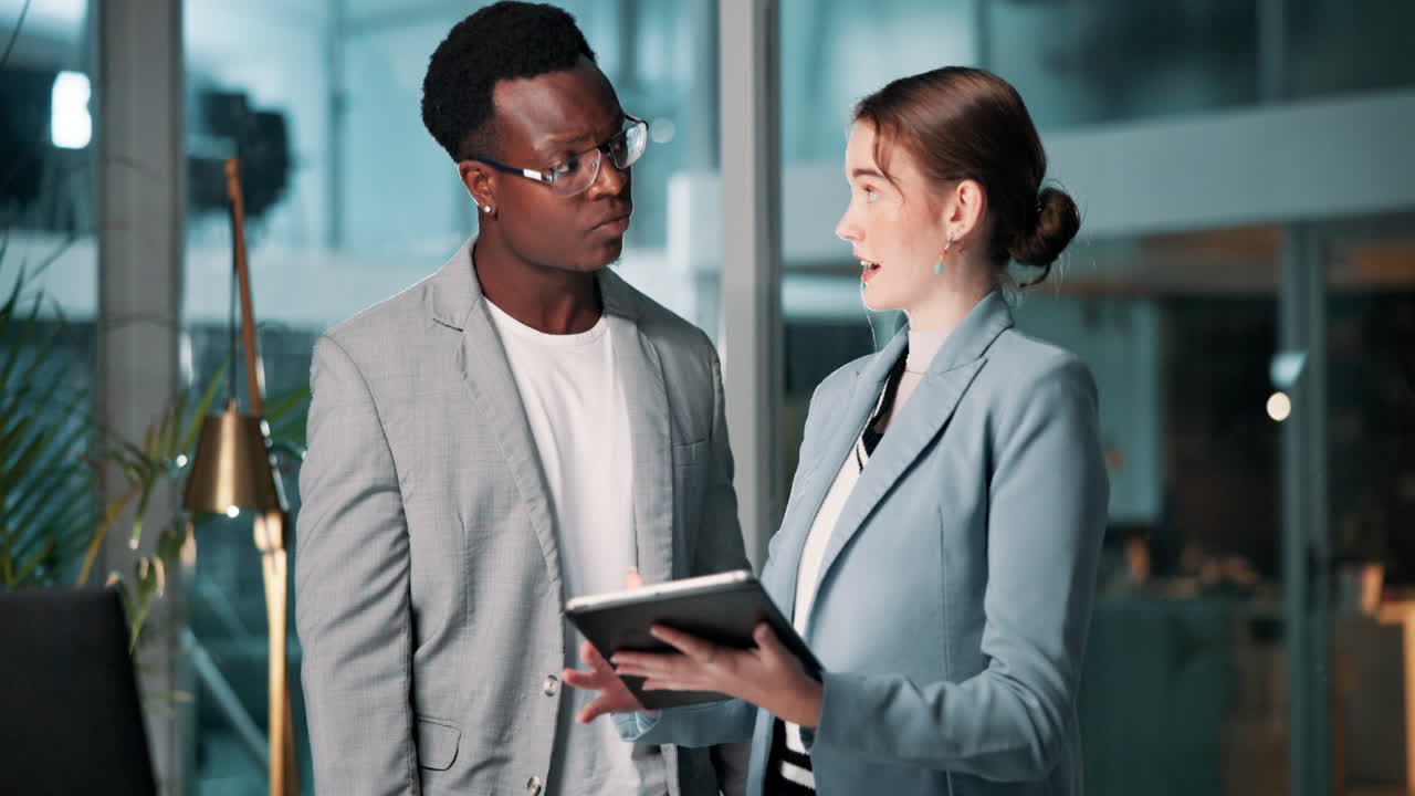 Business professionals discussing work on a tablet