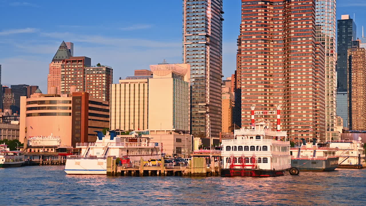 New York, USA, 4 August 2025: Ferry boats docked at Manhattan waterfront New York. Scenic view of ferry boats docked at the Manhattan waterfront with modern skyscrapers in the background