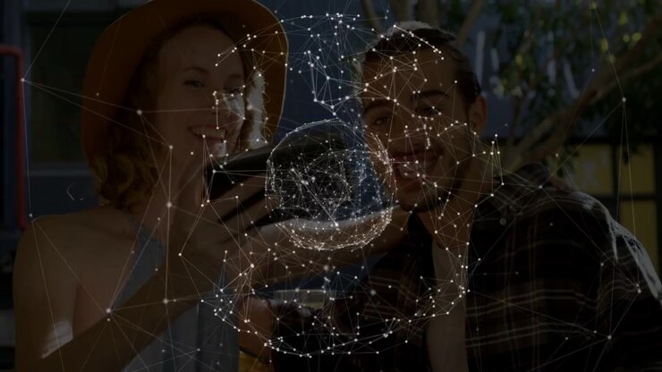 Woman holding smartphone and man leaning watching AR tech sphere orbiting phone, revealing smiles
