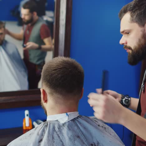 Friendly-Barber-Dries-Hair-Of-His-Client-In-Barbershop-02