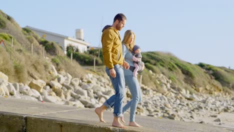 Vista-Lateral-De-Una-Familia-Caucásica-Caminando-En-La-Playa-En-Un-Día-Soleado-4k