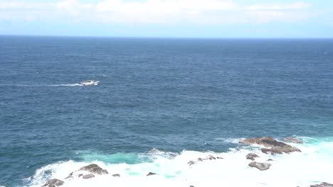 fishing trawler fishing boat sailing in deep blue ocean