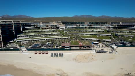 Solaz-Los-Cabos-Resort-with-beach-sand-and-lounge-chairs