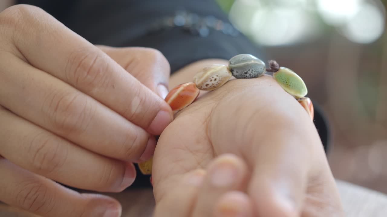 Hand with beaded bracelet