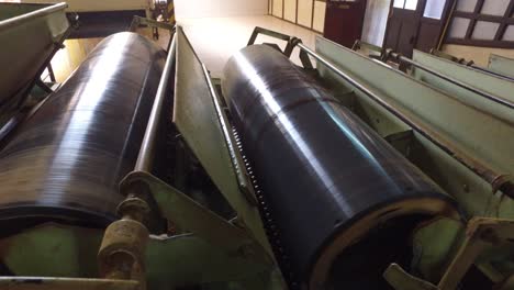 vintage machine conveyor rolls spinning at factory