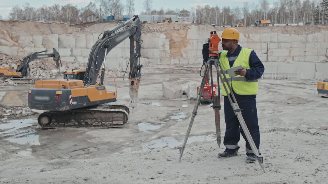 Arab Man Using Surveying Measuring Equipment in Quarry