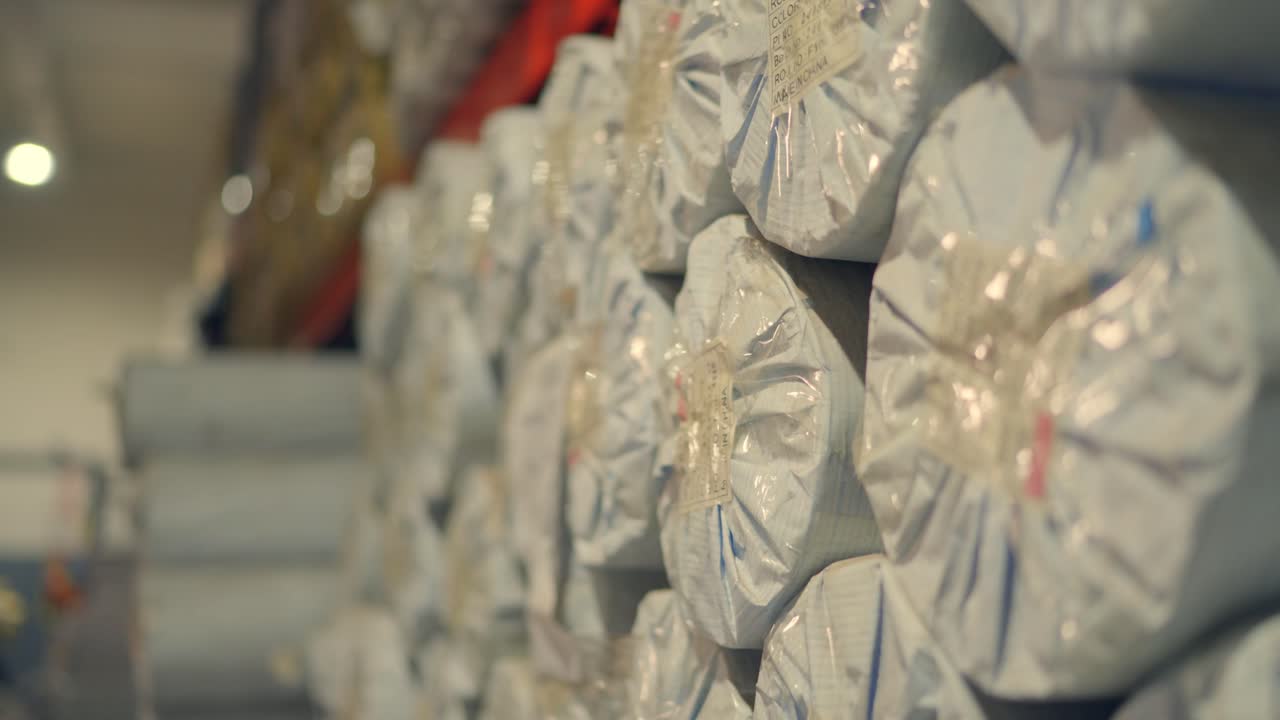 Close-up of packed fabric rolls stacked in a tent making factory in Sialkot, Pakistan
