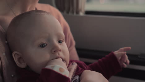 Baby-girl-in-car-with-fingers-in-her-mouth