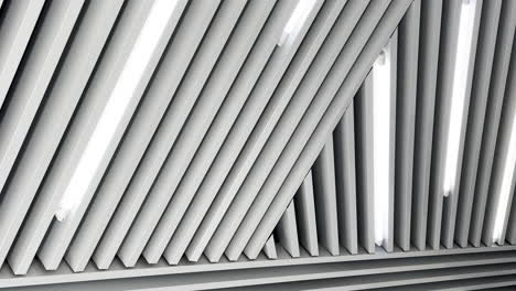 black and white image of led lamps working on the embossed ceiling. low angle perspective.
