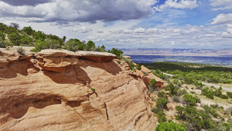 drone flyby of the colorado national monument and distant grand valley