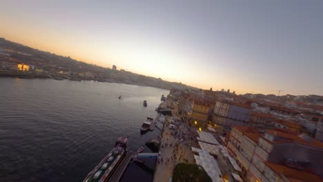 fpv of historic and touristic ribeira neighborhood overlooking douro river, porto, portugal