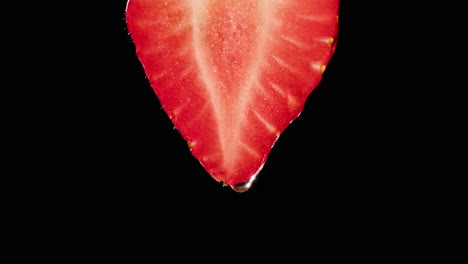 close-up of a strawberry slice with a water droplet