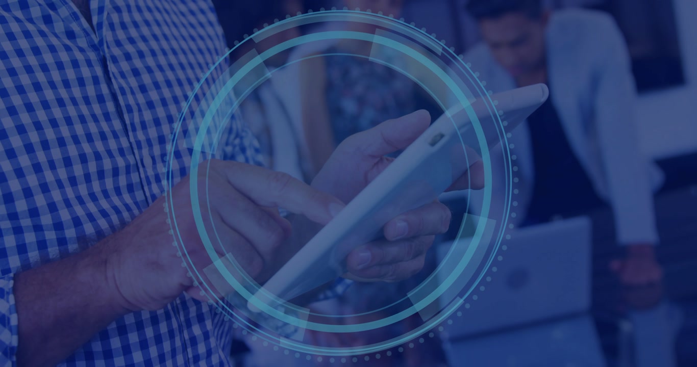 Man tapping tablet causing circular HUD growing rotating settling while business team collaborating
