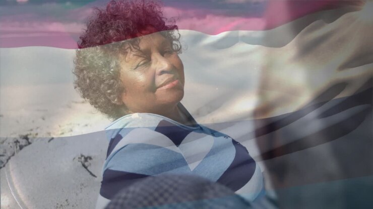 Senior woman responding to man speaking on beach, smiling while pink blue overlay tints for health