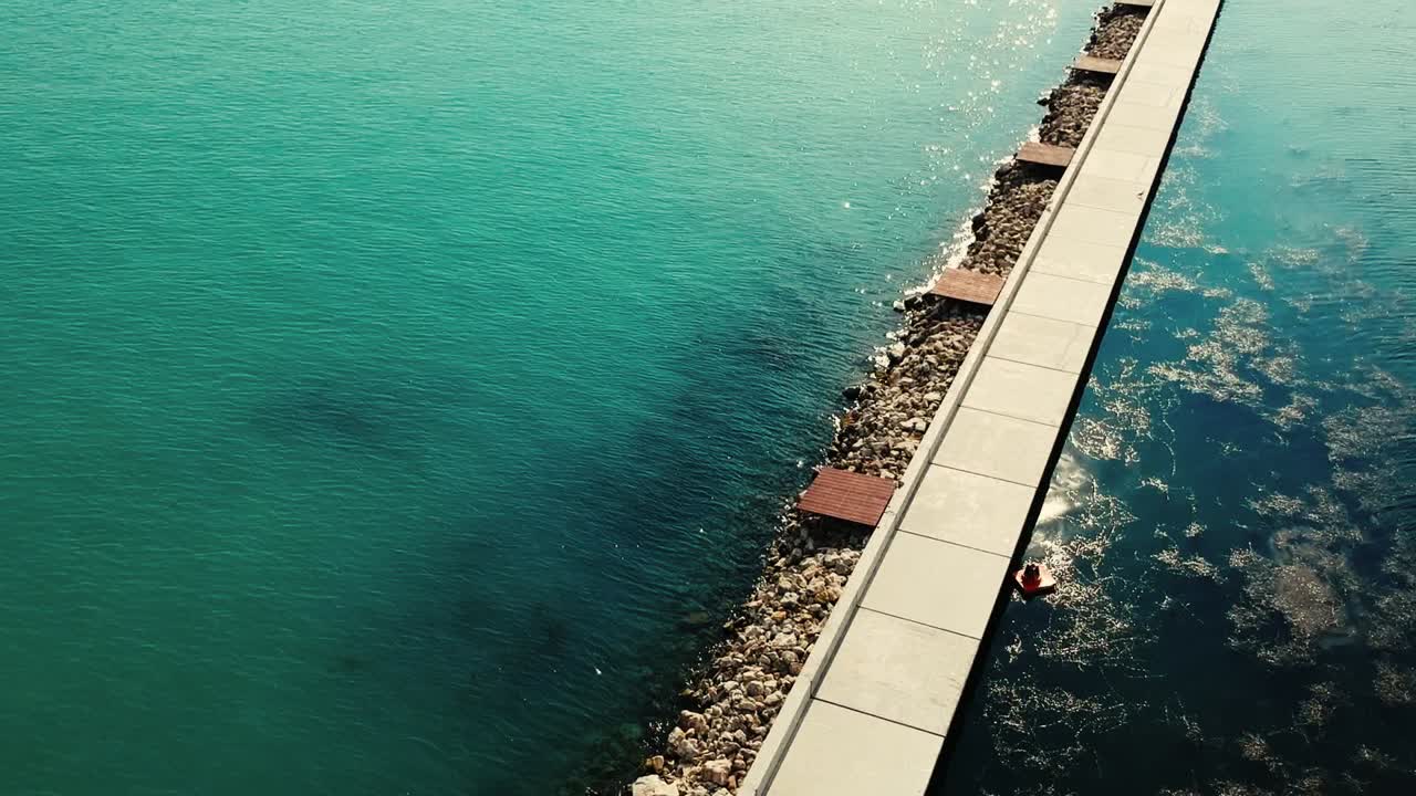 Drone footage of Balaton dockyard and its little bay, beautiful green water and ships everywhere.