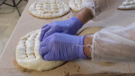 baker-shapes-the-pita-dough