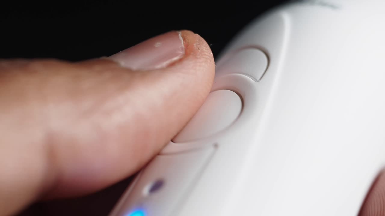 Close up of a finger pressing a button