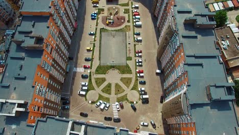top down view of infrastructure of a modern residential area. modern place with parked cars between high-raised buildings. drone video footage.