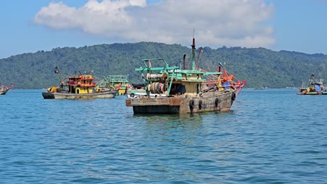 wooden fishing vessels floating in the sea in kota kinabalu, sabah, malaysia. wide static shot