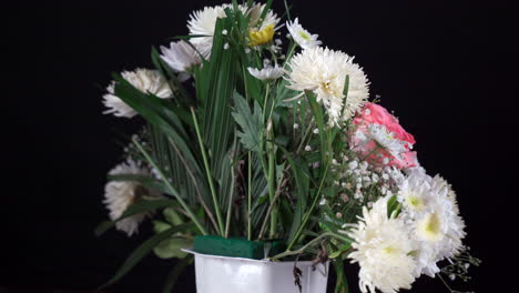 Pequeño-Arreglo-Floral-De-Cementerio-Girando-En-Fondo-Negro-Blanco-Y-Rosa