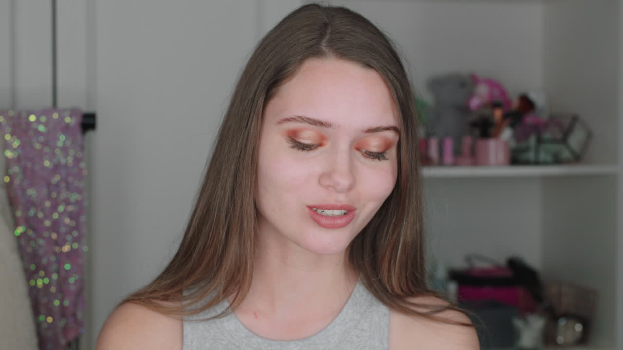 beautiful teenage girl vlogger filming makeup tutorial sharing beauty video enjoying social media influencer recording vlog at home