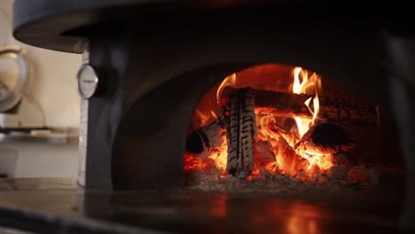 kitchen stone oven burning fire wood ar italian pizza restaurant. cook concept.