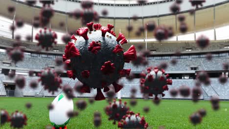 Multiple-covid-19-cells-floating-against-rugby-ball-on-sports-stadium