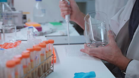 medical laboratory scientist preparing specimen sample using single-channel pipette