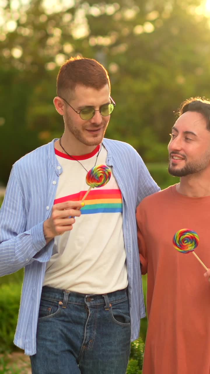 Two men with lollipops celebrate pride and friendship