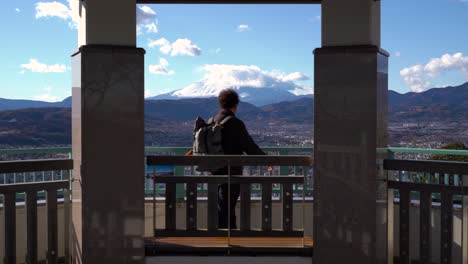 tokyo, japan - a tourist guy overlooking the wide landscape from the terrace where the iconic mt